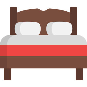 wooden bed with white pillows and red bedding